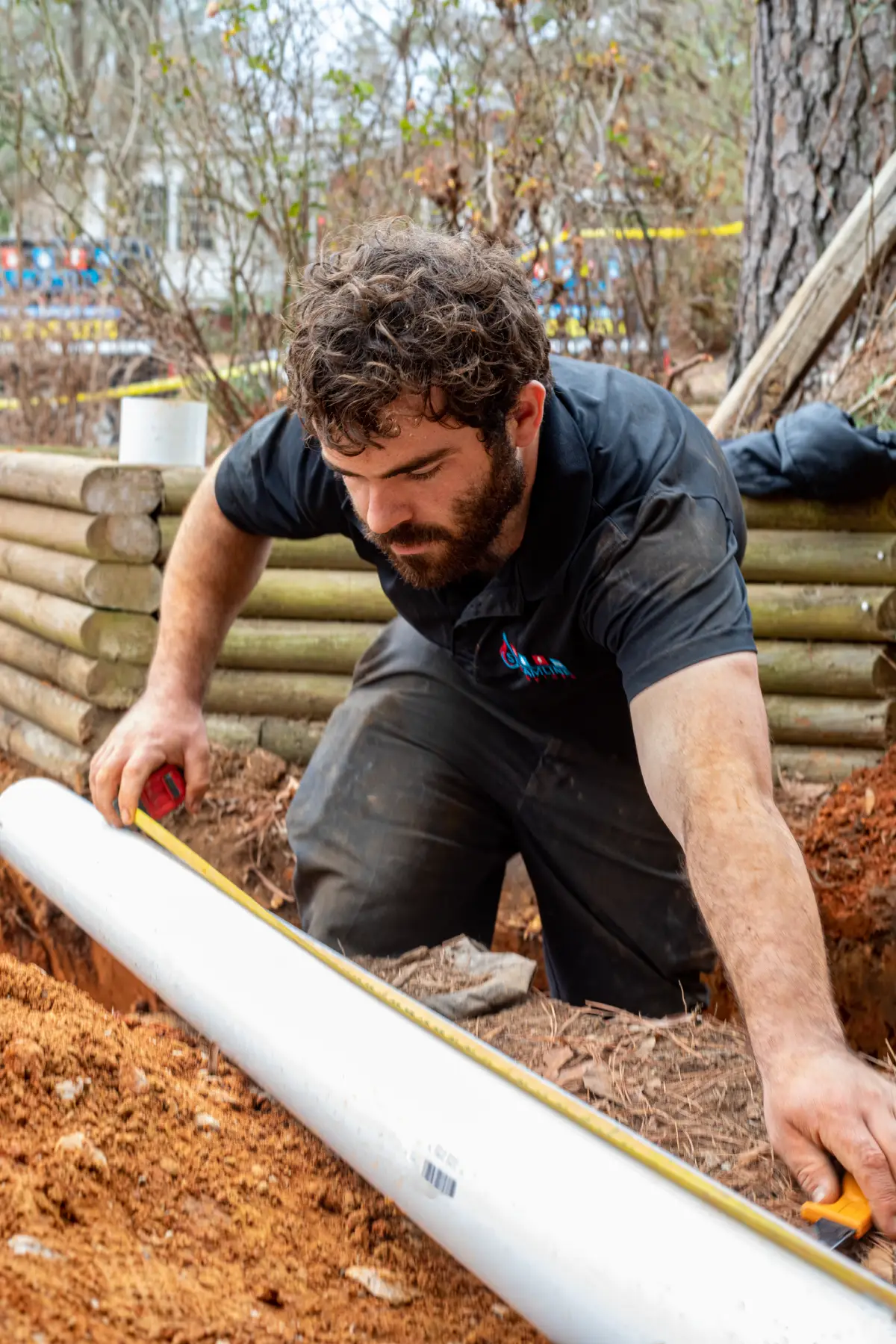 Sewer line repair by a streamline technician. Measuring out a sewer pipe