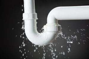 water leaking and spraying out of home plumbing piping