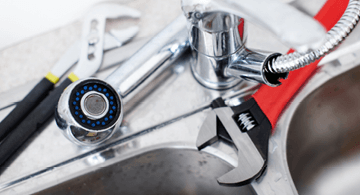 Plumber repair tools with wrench, socket, and pliers