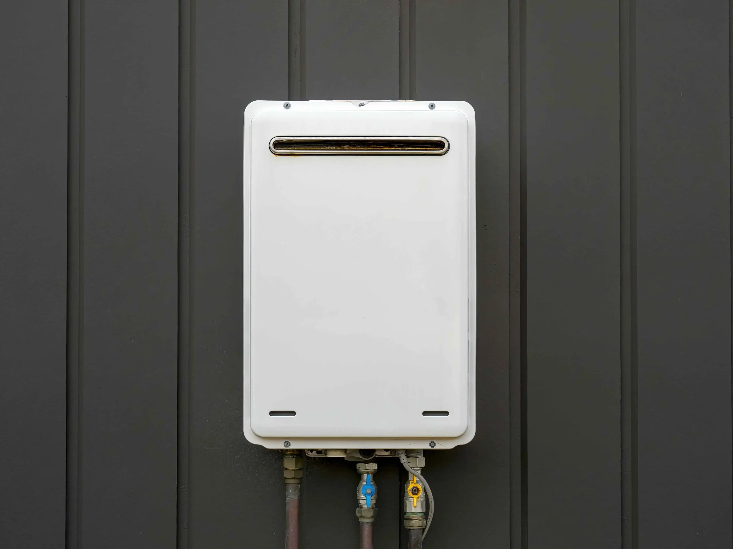 Modern external continuous flow gas water heater mounted on house wall
