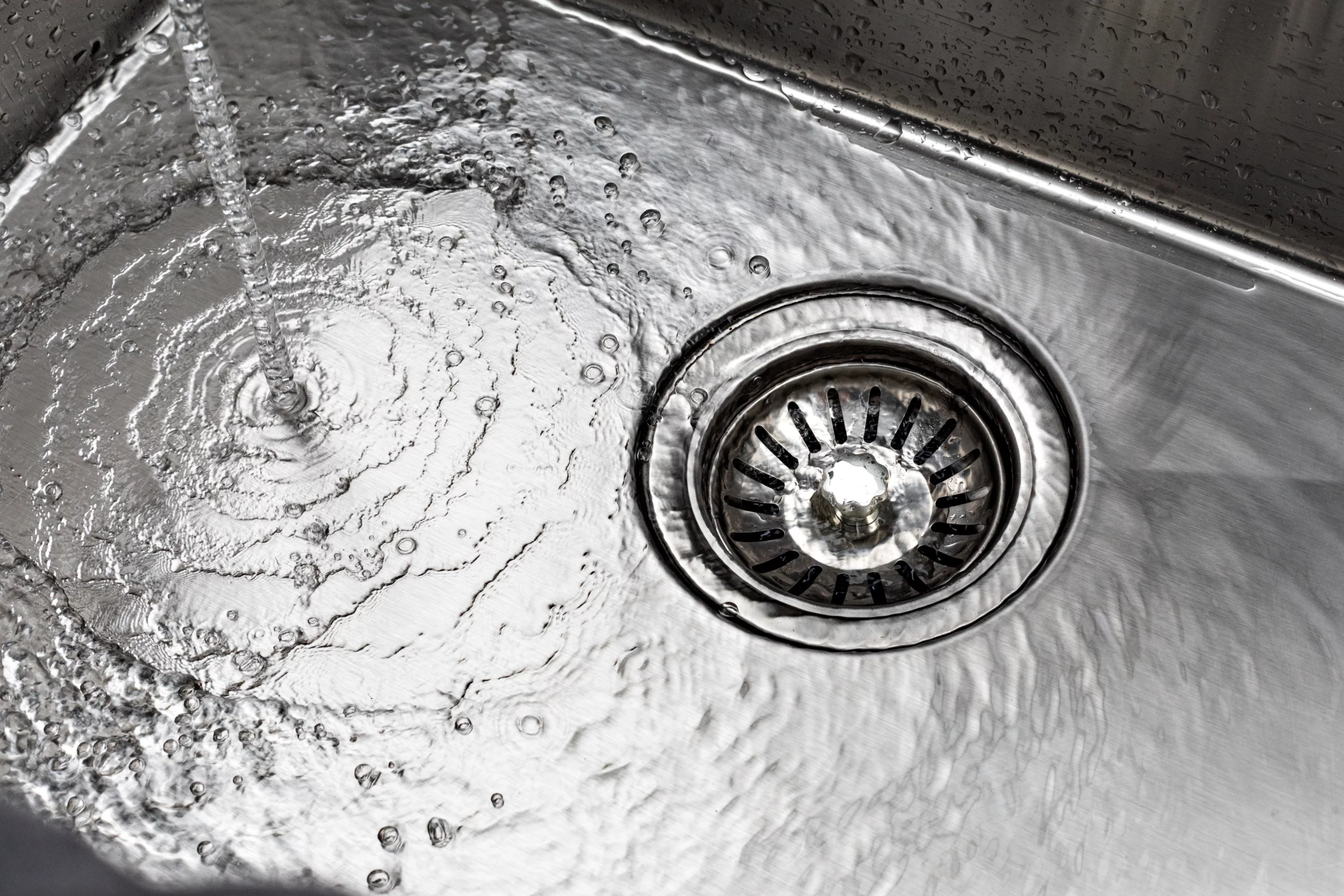 water pouring down clear drain