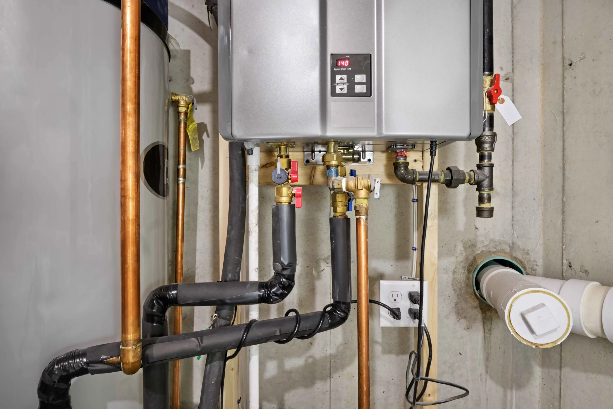Tankless water or on demand water heater system in basement