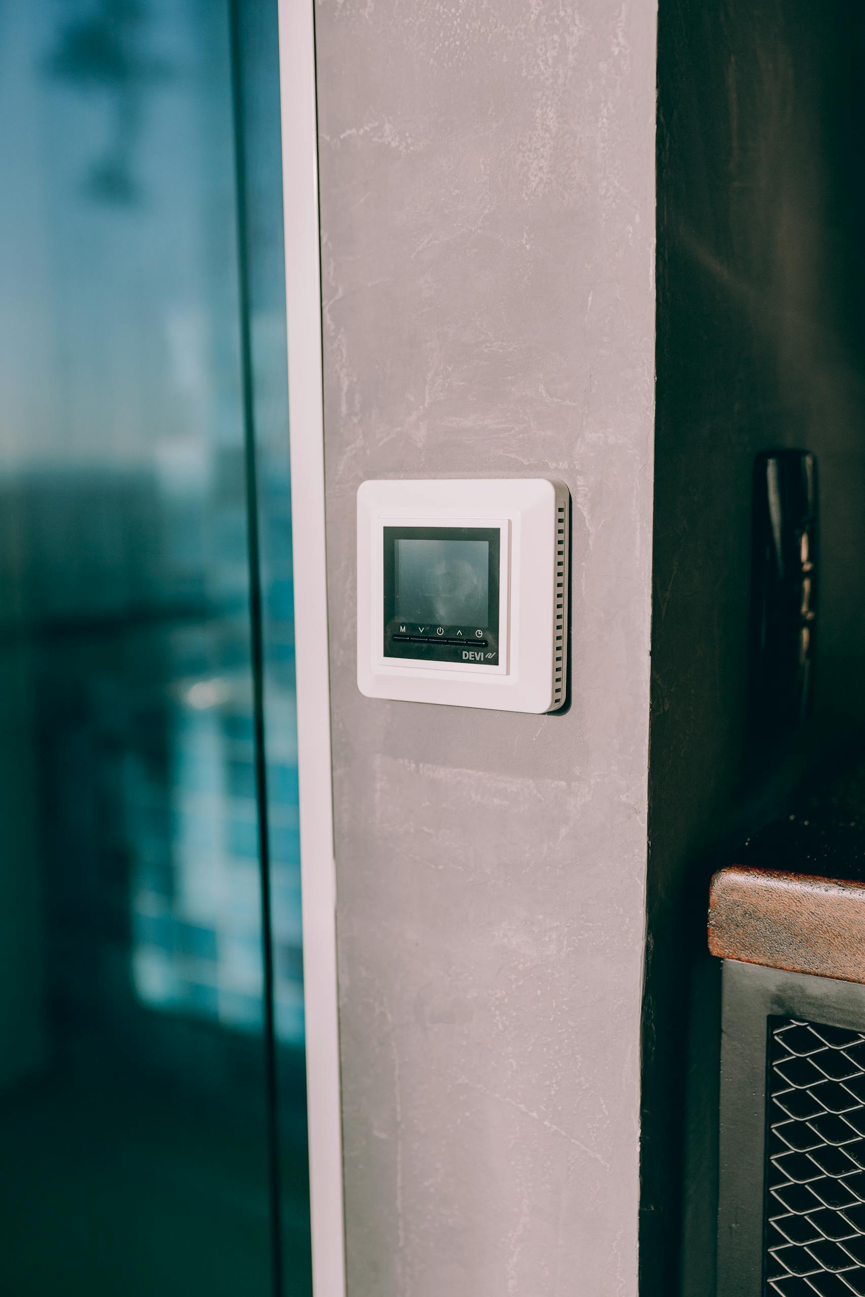 Smart thermostat mounted on a concrete wall